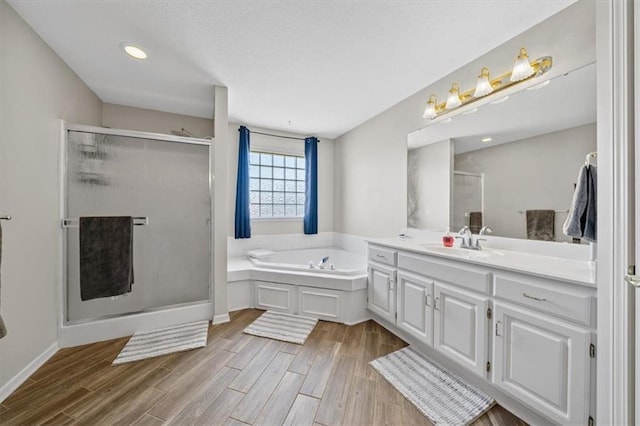 2312 SW Post Oak Ct, Lees Summit, MO 64082 - bathroom featuring a stall shower, a bath, vanity, and wood finished floors