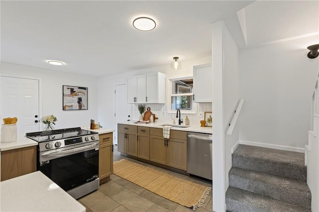 3029 S 9th Pl, Kansas City, KS 66103 - kitchen featuring appliances with stainless steel finishes and light countertops