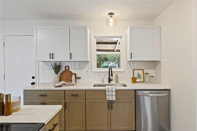 3029 S 9th Pl, Kansas City, KS 66103 - kitchen with stainless steel dishwasher, backsplash, and light countertops