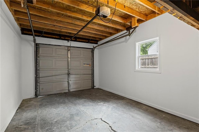 3029 S 9th Pl, Kansas City, KS 66103 - garage featuring a garage door opener and baseboards