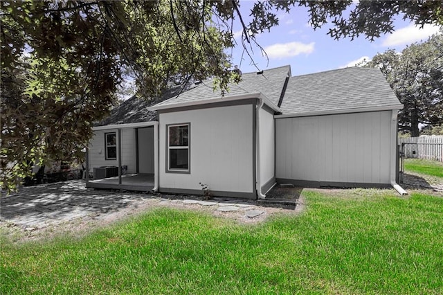 3029 S 9th Pl, Kansas City, KS 66103 - back of house featuring roof with shingles and a patio