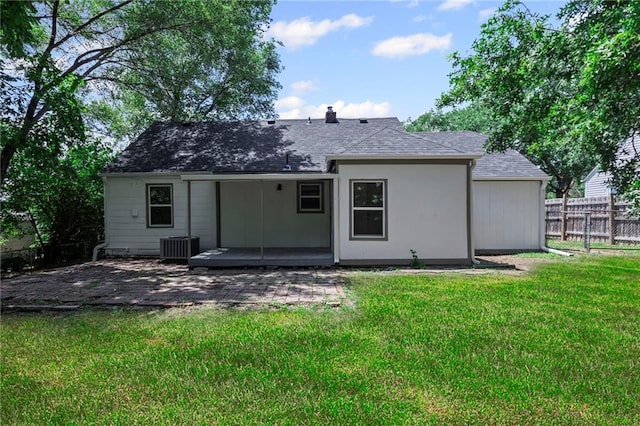 3029 S 9th Pl, Kansas City, KS 66103 - back of house featuring a patio and roof with shingles