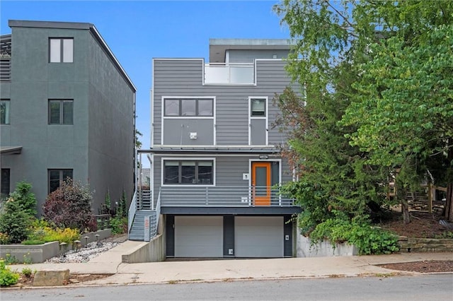 1303 W 47th St, Kansas City, MO 64112 - modern home featuring stairway and a garage