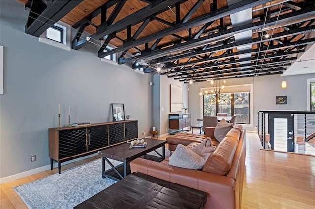 1303 W 47th St, Kansas City, MO 64112 - living area with a chandelier, wood finished floors, and a high ceiling