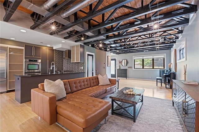 1303 W 47th St, Kansas City, MO 64112 - living area featuring light wood finished floors and baseboards