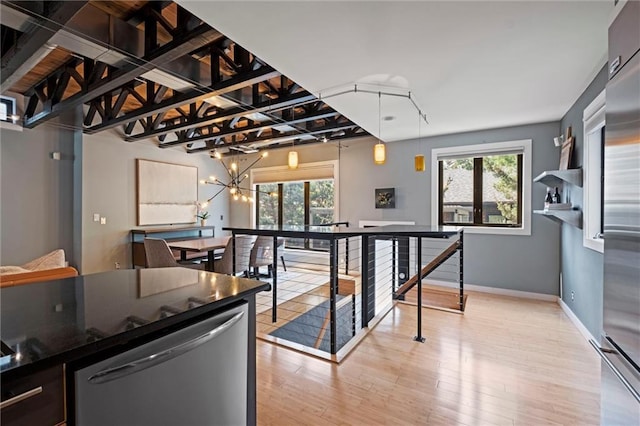 1303 W 47th St, Kansas City, MO 64112 - kitchen featuring dishwashing machine, high quality fridge, light wood-style floors, a chandelier, and hanging light fixtures