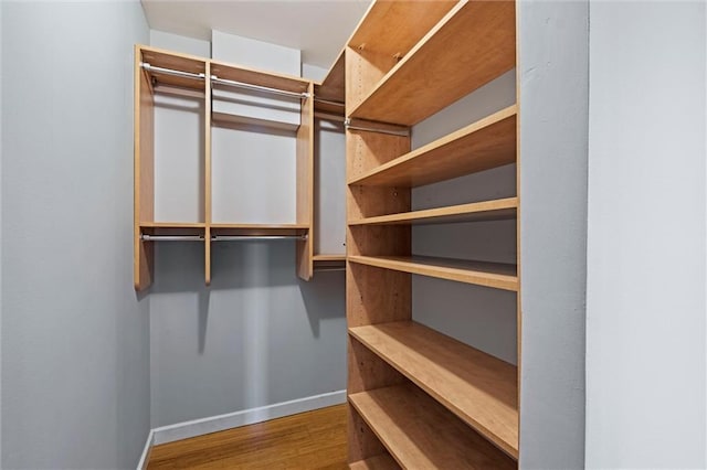 1303 W 47th St, Kansas City, MO 64112 - walk in closet featuring wood finished floors