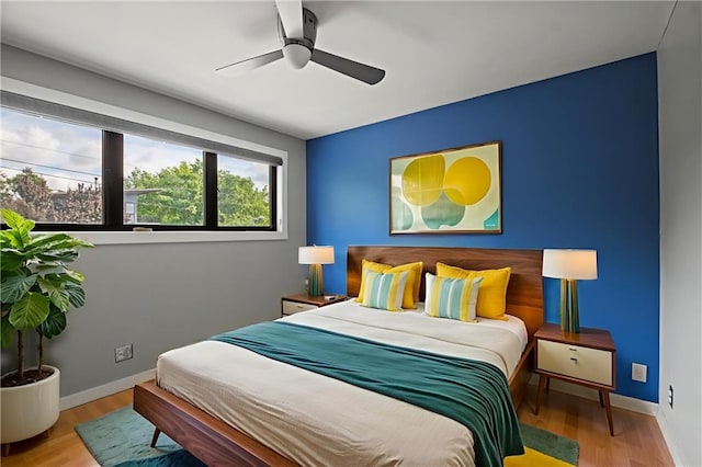 1303 W 47th St, Kansas City, MO 64112 - bedroom featuring wood finished floors and ceiling fan