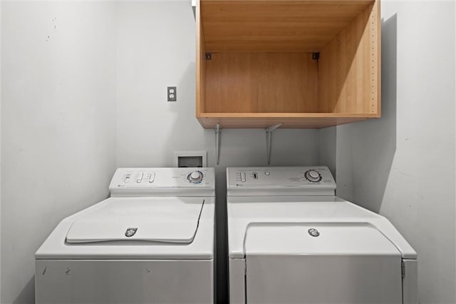 1303 W 47th St, Kansas City, MO 64112 - laundry room featuring cabinet space and washer and clothes dryer
