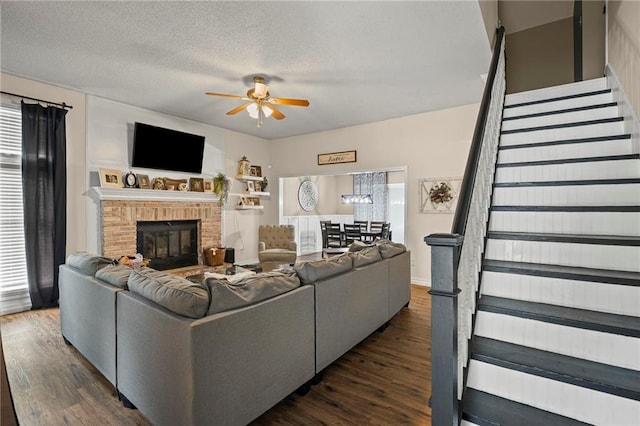 17507 E 35th Ter, Independence, MO 64055 - living room with stairs, a ceiling fan, dark wood-style floors, healthy amount of natural light, and a textured ceiling