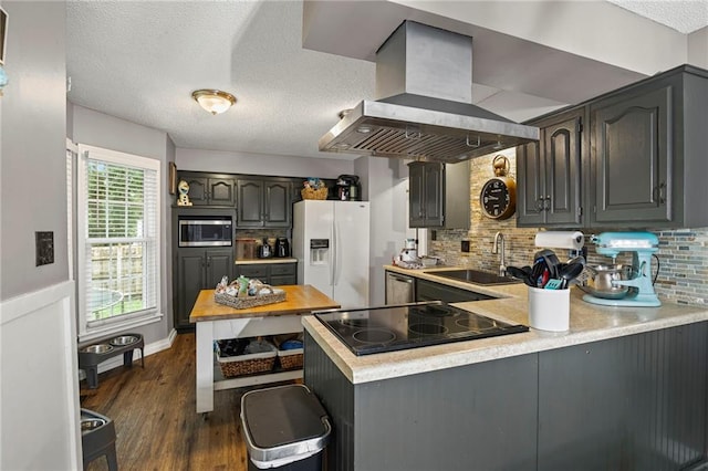 17507 E 35th Ter, Independence, MO 64055 - kitchen featuring island exhaust hood, white refrigerator with ice dispenser, black electric cooktop, a peninsula, and stainless steel microwave