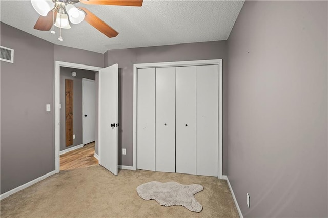 17507 E 35th Ter, Independence, MO 64055 - unfurnished bedroom featuring carpet, a textured ceiling, a closet, and a ceiling fan