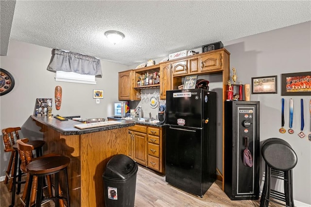 17507 E 35th Ter, Independence, MO 64055 - indoor dry bar with freestanding refrigerator, a textured ceiling, and light wood-style floors