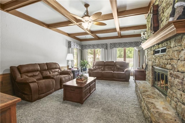 2005 NW Fawn Dr, Blue Springs, MO 64015 - living room featuring coffered ceiling, a ceiling fan, carpet, beam ceiling, and a stone fireplace