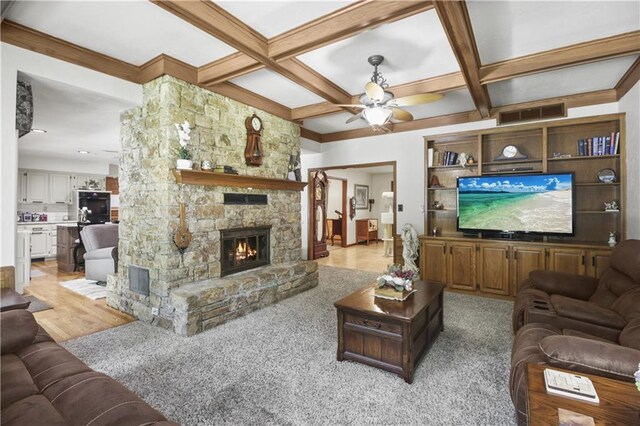 2005 NW Fawn Dr, Blue Springs, MO 64015 - living area featuring a fireplace, ceiling fan, beam ceiling, and coffered ceiling