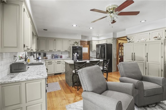 2005 NW Fawn Dr, Blue Springs, MO 64015 - kitchen with fridge with ice dispenser, a ceiling fan, decorative backsplash, recessed lighting, and open floor plan