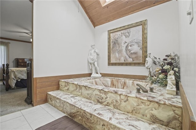 2005 NW Fawn Dr, Blue Springs, MO 64015 - full bathroom featuring lofted ceiling, ensuite bathroom, a skylight, tile patterned floors, and a tub with marble appearance