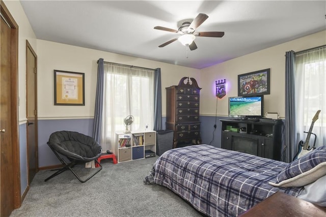2005 NW Fawn Dr, Blue Springs, MO 64015 - carpeted bedroom featuring multiple windows and a ceiling fan