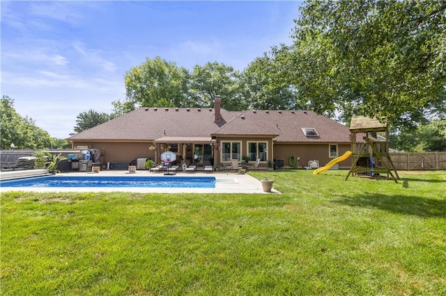 2005 NW Fawn Dr, Blue Springs, MO 64015 - rear view of house featuring a patio and a playground