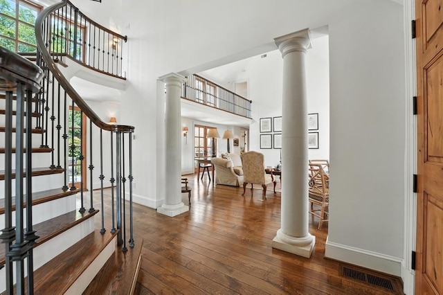 28 Le Mans Ct, Prairie Village, KS 66208 - entryway with decorative columns, a high ceiling, dark wood-style flooring, and stairs