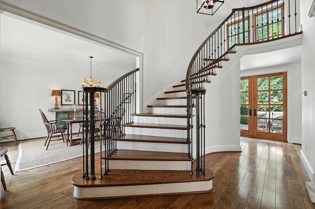 28 Le Mans Ct, Prairie Village, KS 66208 - staircase featuring a chandelier, wood-type flooring, and a high ceiling