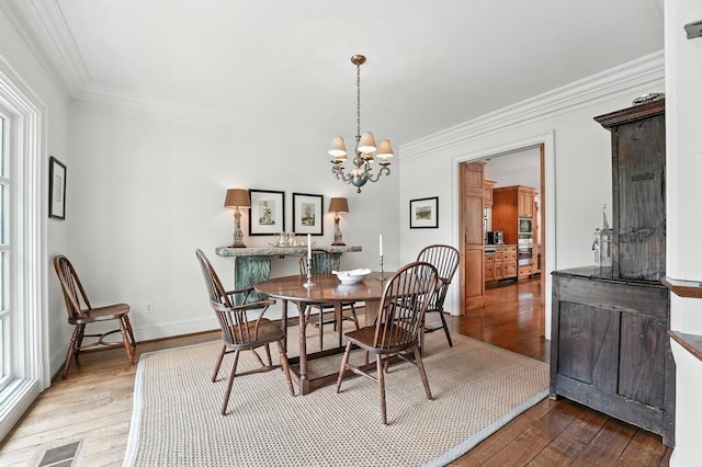28 Le Mans Ct, Prairie Village, KS 66208 - dining area with hardwood / wood-style flooring, crown molding, and a chandelier