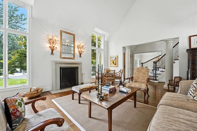 28 Le Mans Ct, Prairie Village, KS 66208 - living area with a high ceiling, plenty of natural light, wood finished floors, a fireplace with raised hearth, and stairway