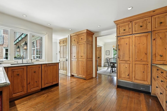 28 Le Mans Ct, Prairie Village, KS 66208 - kitchen with dark wood finished floors, brown cabinetry, recessed lighting, and light stone countertops