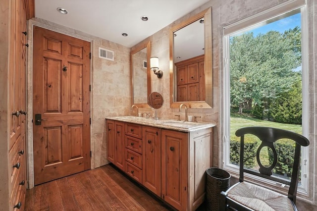 28 Le Mans Ct, Prairie Village, KS 66208 - bathroom with tile walls, double vanity, wood finished floors, and healthy amount of natural light