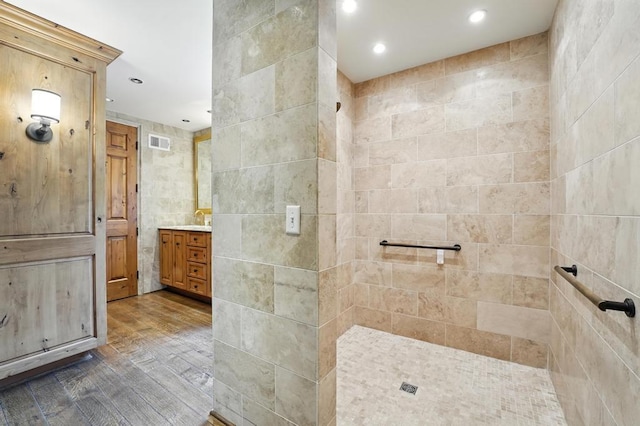 28 Le Mans Ct, Prairie Village, KS 66208 - bathroom with tile walls, vanity, a walk in shower, wood finished floors, and recessed lighting