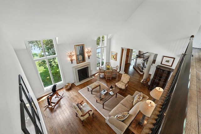 28 Le Mans Ct, Prairie Village, KS 66208 - living room with a towering ceiling, a fireplace with flush hearth, and hardwood / wood-style flooring