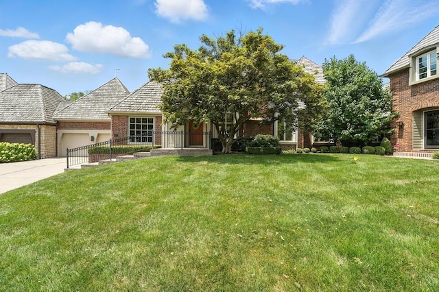 28 Le Mans Ct, Prairie Village, KS 66208 - view of front of home featuring an attached garage, brick siding, a front yard, and driveway