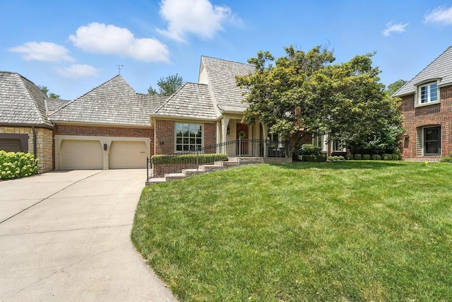 28 Le Mans Ct, Prairie Village, KS 66208 - view of front of home with an attached garage, brick siding, a front yard, and concrete driveway