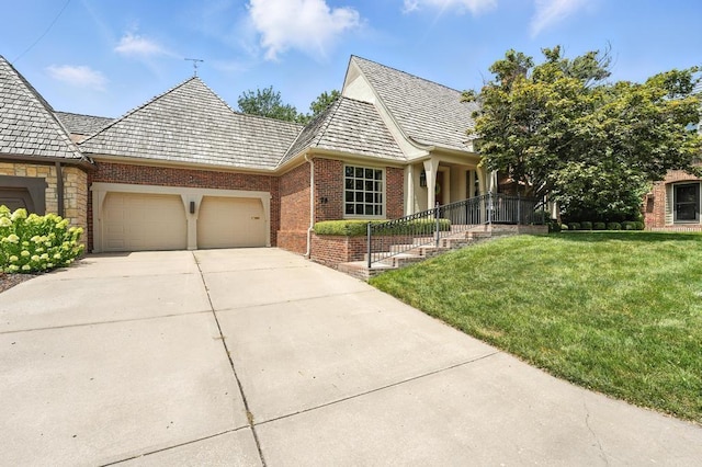 28 Le Mans Ct, Prairie Village, KS 66208 - view of front facade with brick siding, a garage, a front lawn, and driveway