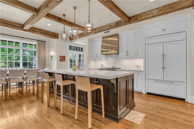 10400 Howe Dr, Leawood, KS 66206 - kitchen with light wood-style flooring, paneled refrigerator, healthy amount of natural light, and beam ceiling