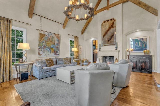 10400 Howe Dr, Leawood, KS 66206 - living area with a fireplace, a chandelier, hardwood / wood-style flooring, beam ceiling, and high vaulted ceiling