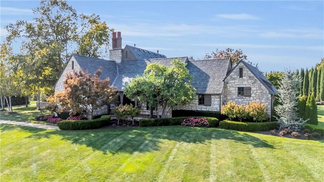 10400 Howe Dr, Leawood, KS 66206 - rear view of house featuring stone siding, a high end roof, a chimney, and a yard