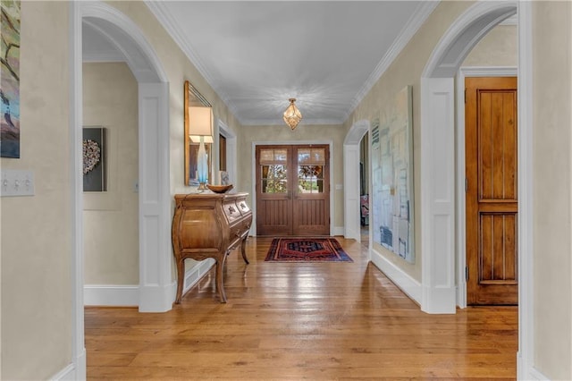 10400 Howe Dr, Leawood, KS 66206 - entryway with arched walkways, light wood finished floors, and crown molding