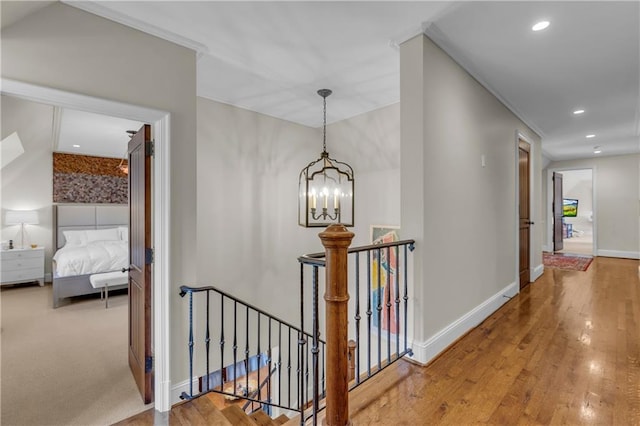 10400 Howe Dr, Leawood, KS 66206 - hallway with an upstairs landing, a chandelier, hardwood / wood-style flooring, and recessed lighting