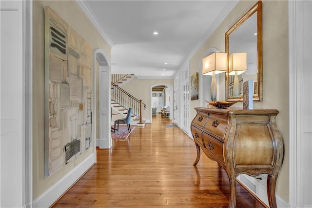 10400 Howe Dr, Leawood, KS 66206 - hall featuring arched walkways, french doors, crown molding, stairs, and light wood-style flooring