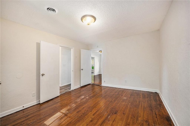 707 N Forest Ave, Independence, MO 64050 - empty room featuring wood-type flooring and a textured ceiling