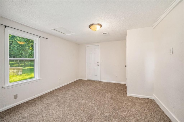 707 N Forest Ave, Independence, MO 64050 - spare room featuring a textured ceiling, carpet, and attic access