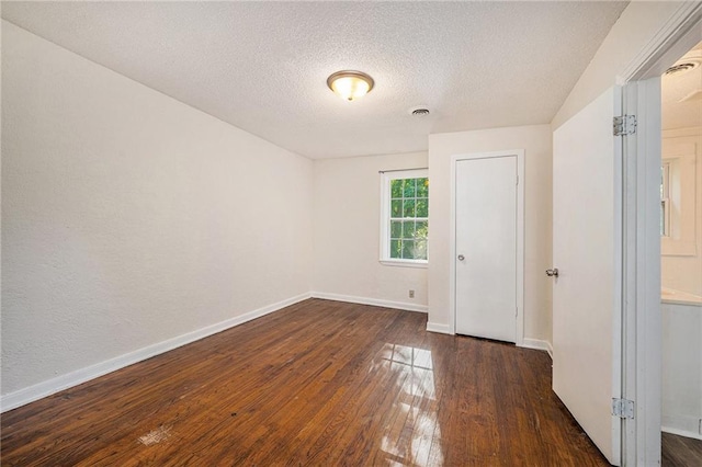 707 N Forest Ave, Independence, MO 64050 - spare room with hardwood / wood-style flooring and a textured ceiling