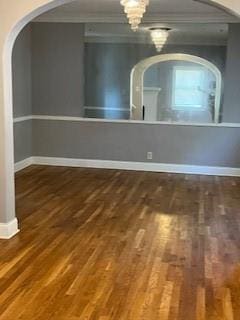 809 W Gregory Blvd, Kansas City, MO 64114 - empty room with arched walkways, wood finished floors, and crown molding