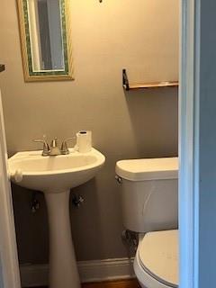 809 W Gregory Blvd, Kansas City, MO 64114 - bathroom featuring toilet and baseboards