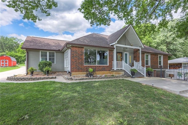 2508 N Mcbride Ave, Sugar Creek, MO 64050 - view of front of property featuring an outdoor structure, a front yard, roof with shingles, and brick siding