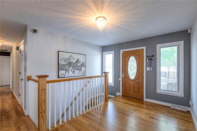 2508 N Mcbride Ave, Sugar Creek, MO 64050 - foyer entrance with wood finished floors and a textured ceiling