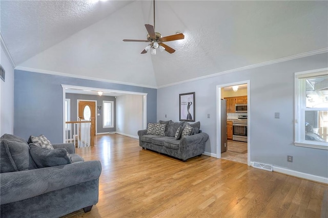 2508 N Mcbride Ave, Sugar Creek, MO 64050 - living area with light wood-type flooring, ceiling fan, high vaulted ceiling, and ornamental molding