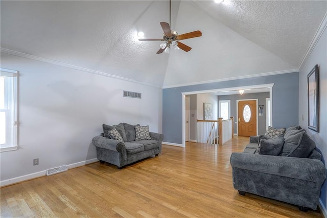 2508 N Mcbride Ave, Sugar Creek, MO 64050 - living area with a textured ceiling, ceiling fan, light wood finished floors, high vaulted ceiling, and ornamental molding