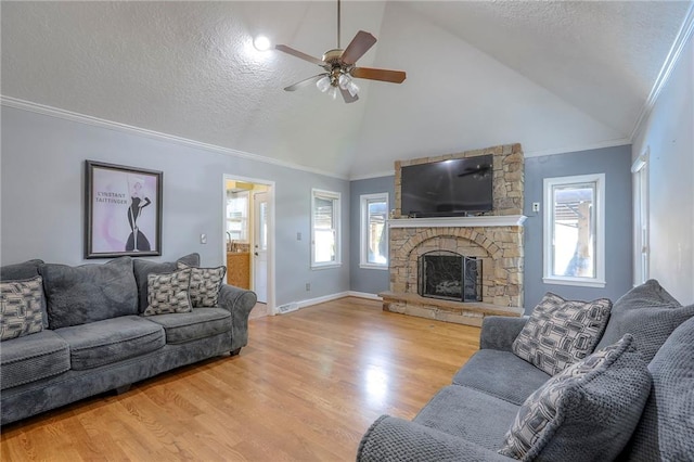 2508 N Mcbride Ave, Sugar Creek, MO 64050 - living area featuring a ceiling fan, healthy amount of natural light, high vaulted ceiling, a fireplace, and wood finished floors
